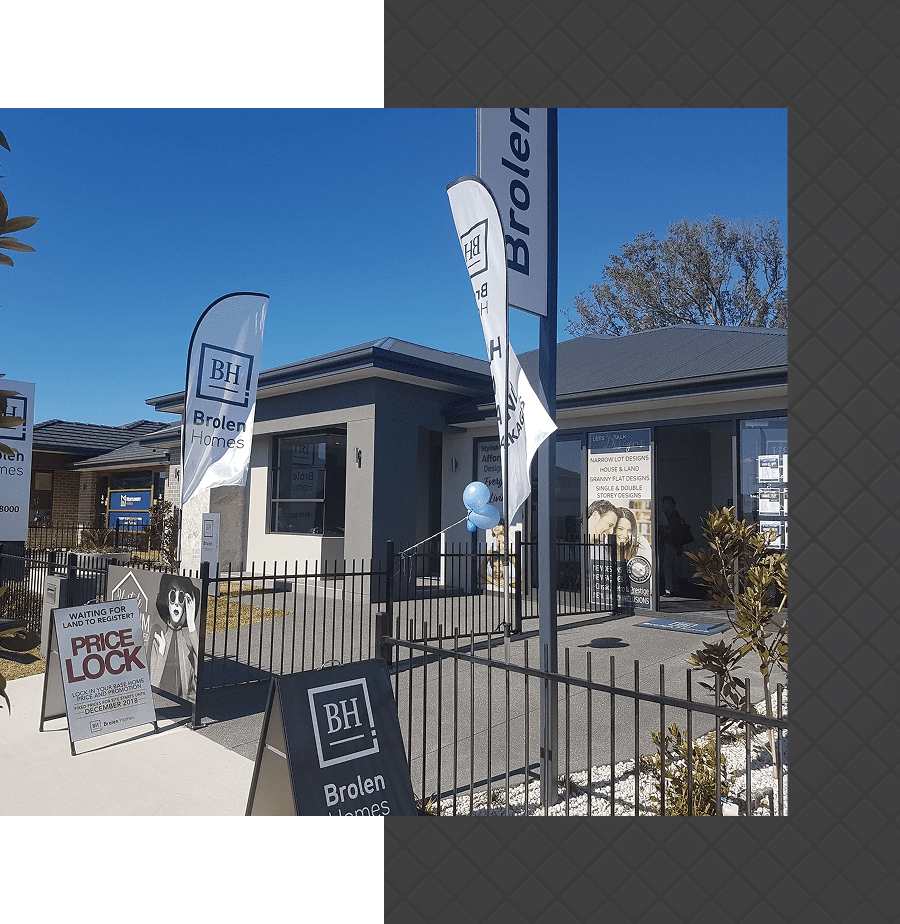 Model home exterior with promotional banners